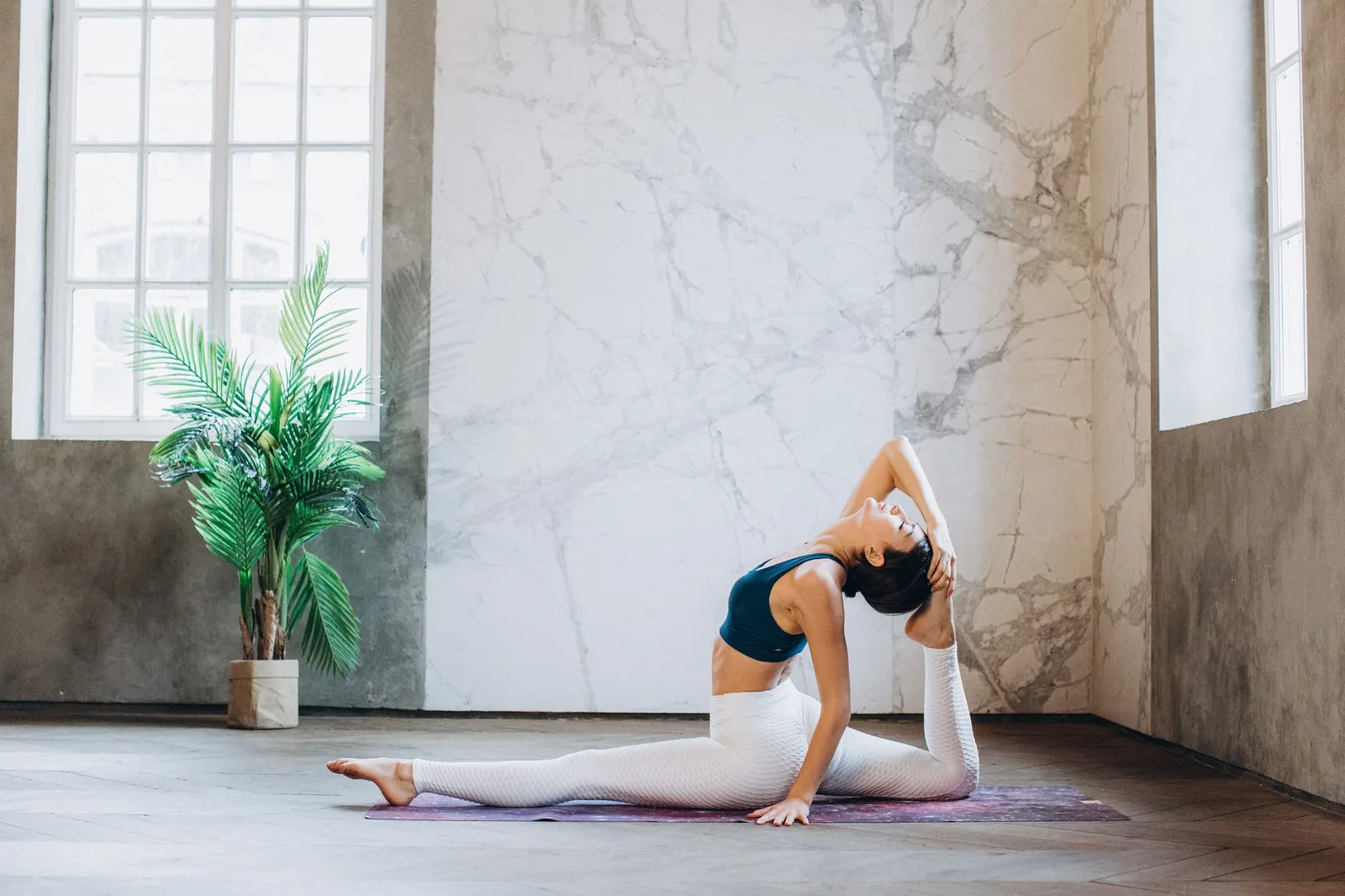 A woman practising yoga in a bright, calm studio